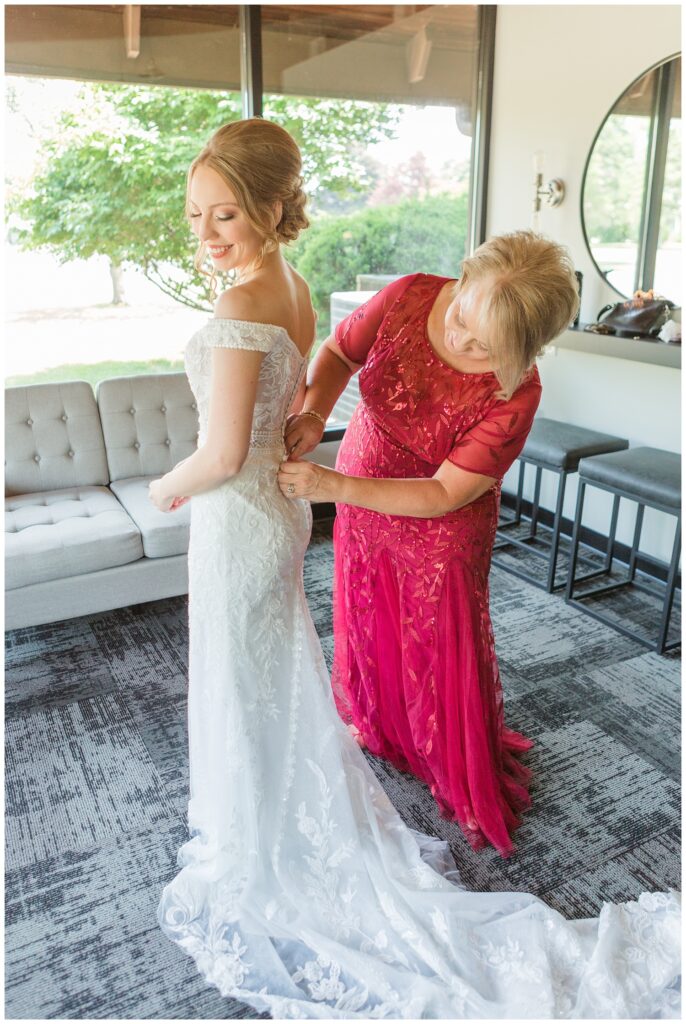 mom zipping up the bride's dress at summer Northwest Ohio wedding