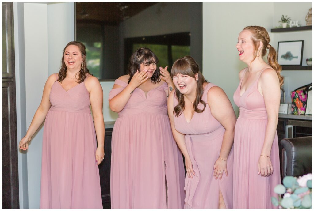 bridesmaids reacting to bride in her dress at summer wedding in northwest Ohio