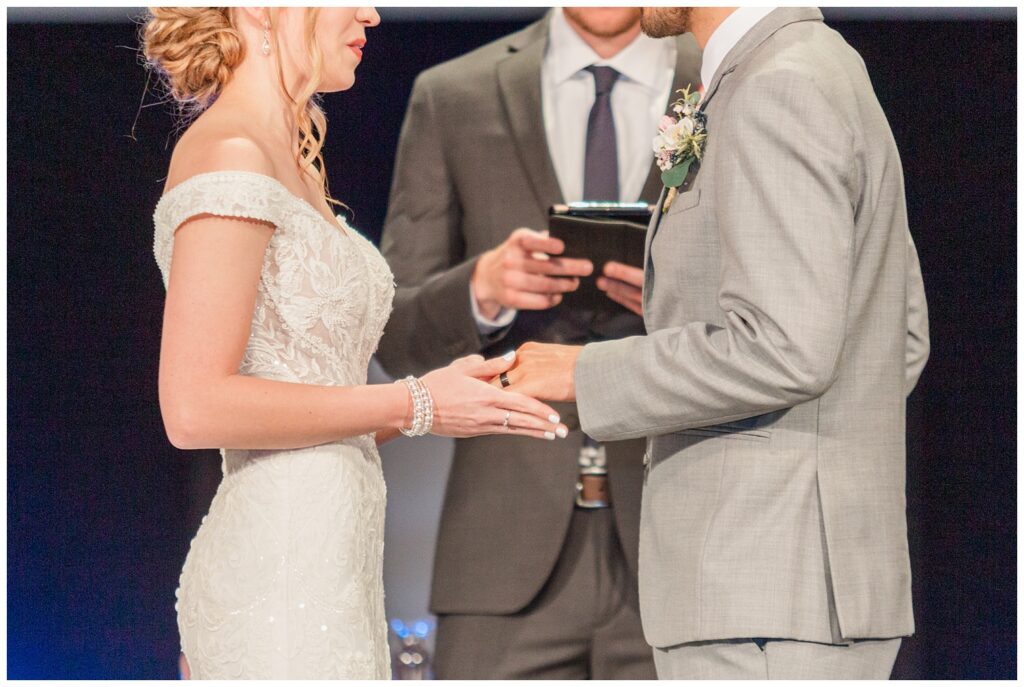 bride and groom exchanging rings at summer Tiffin, Ohio wedding