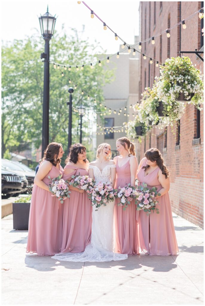bridal party posing on the sidewalk in downtown Tiffin, Ohio