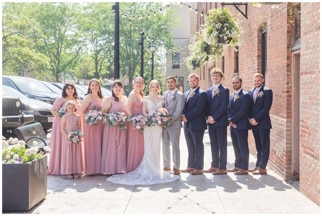 bridal party posing on the sidewalk in downtown Tiffin, Ohio