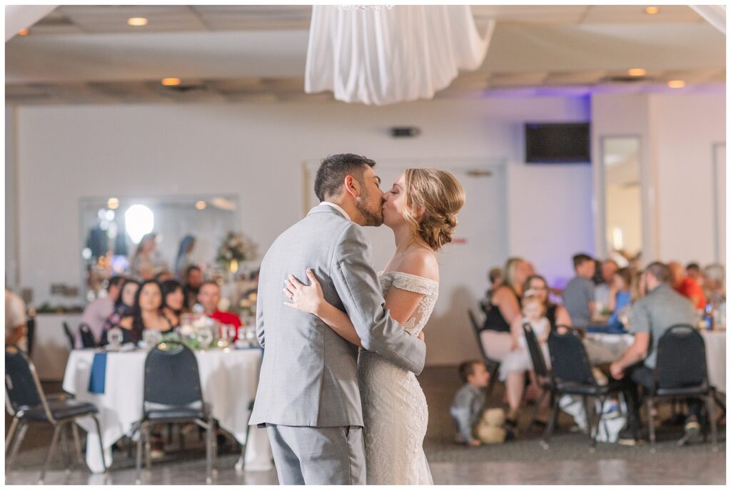 bride and groom kiss after first dance at summer wedding in northwest Ohio