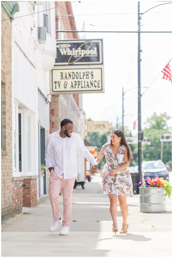 engaged couple laughing in downtown Gibsonburg