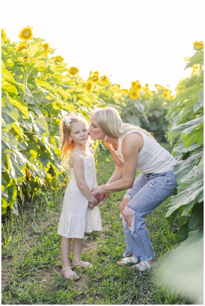 mom and her daughter standing amongst sunflowers in northwest Ohio