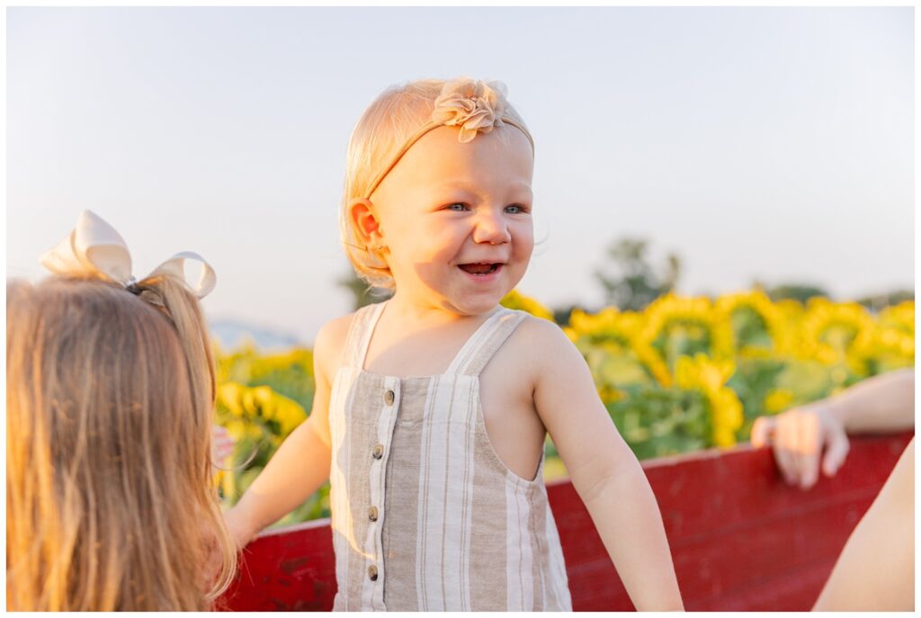 little girl smiling in a sunflower farm in Lindsey, Ohio