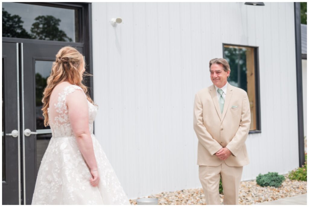bride's first look with her dad at the Village Barn wedding venue