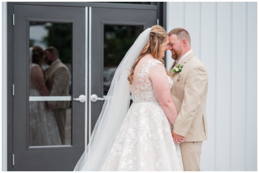 groom and bride touch foreheads during first look 