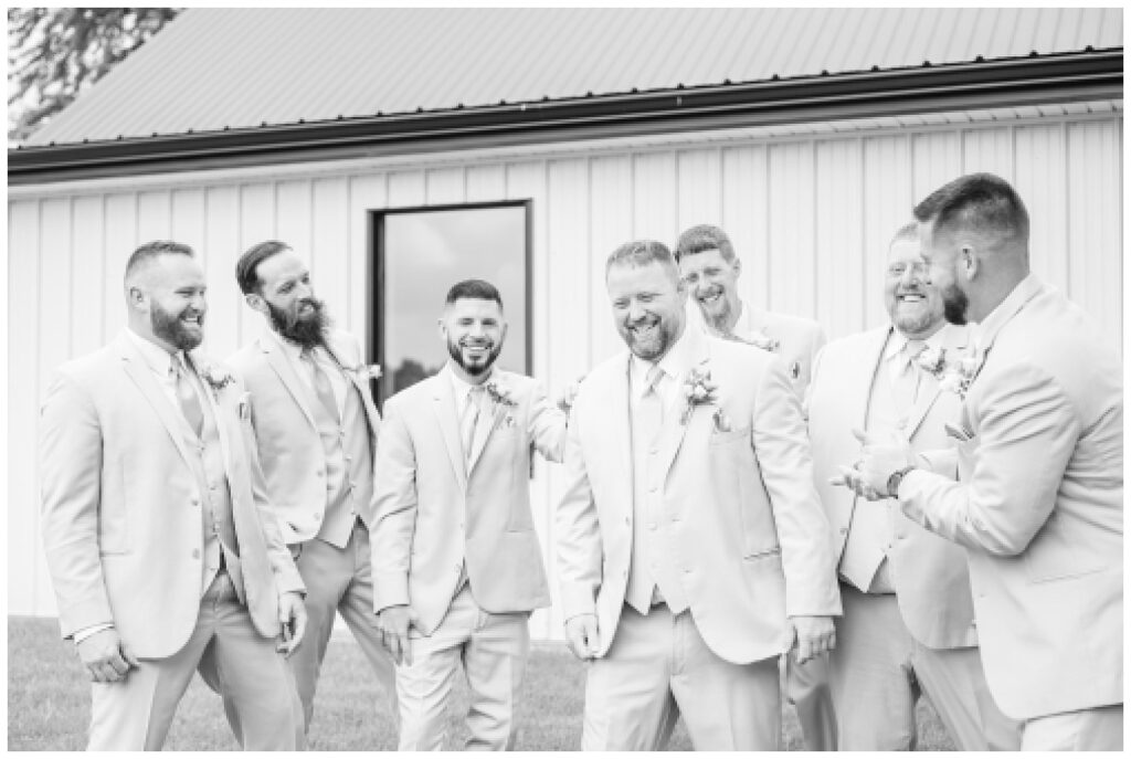 groomsmen laughing at summer wedding in Monroeville, Ohio
