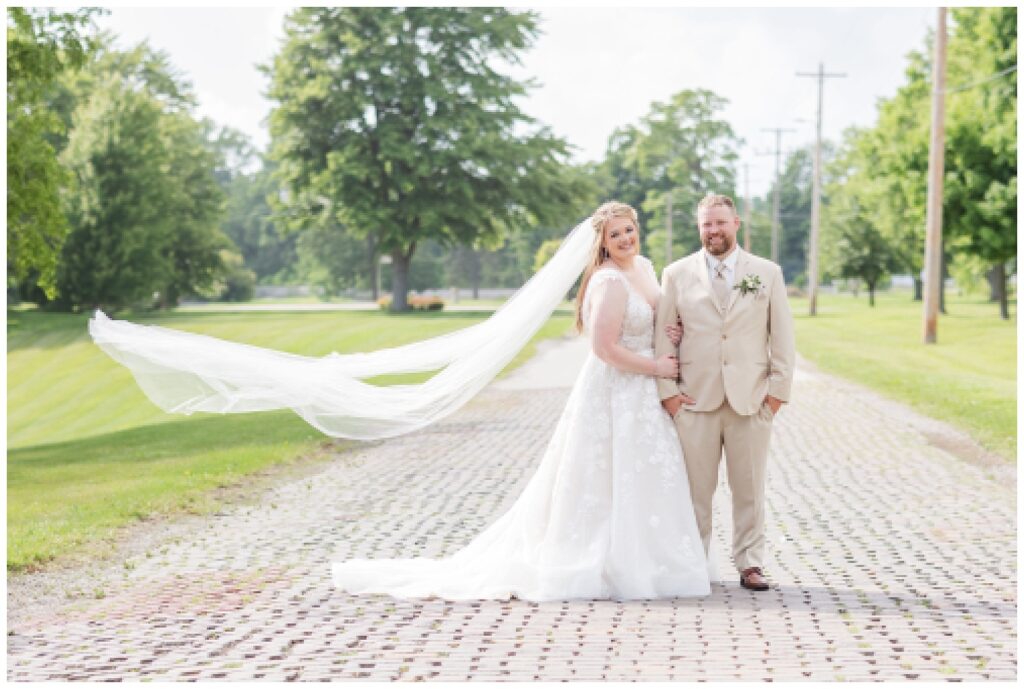 bride and groom standing on a brick road in Monroeville, Ohio