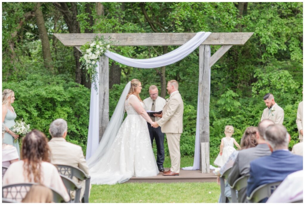 wedding couple exchanging vows at summer ceremony in northwest Ohio