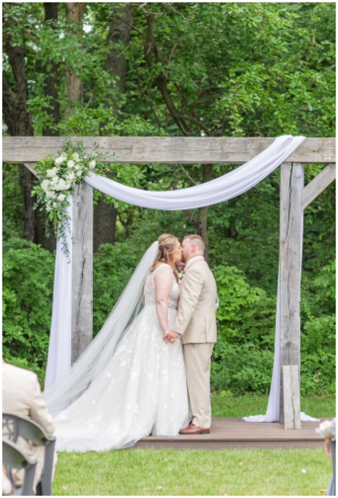 wedding couple kiss at summer ceremony in northwest Ohio