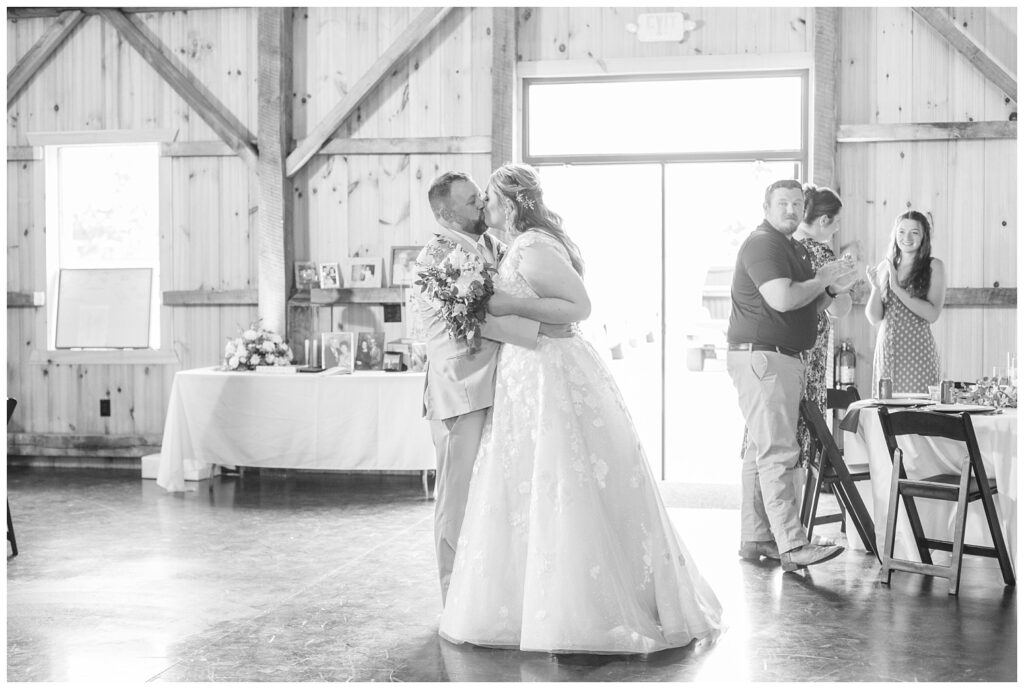 bride and groom's entrance into summer reception at the Village Barn