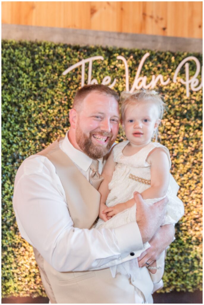 groom holding his daughter at wedding in Monroeville, Ohio