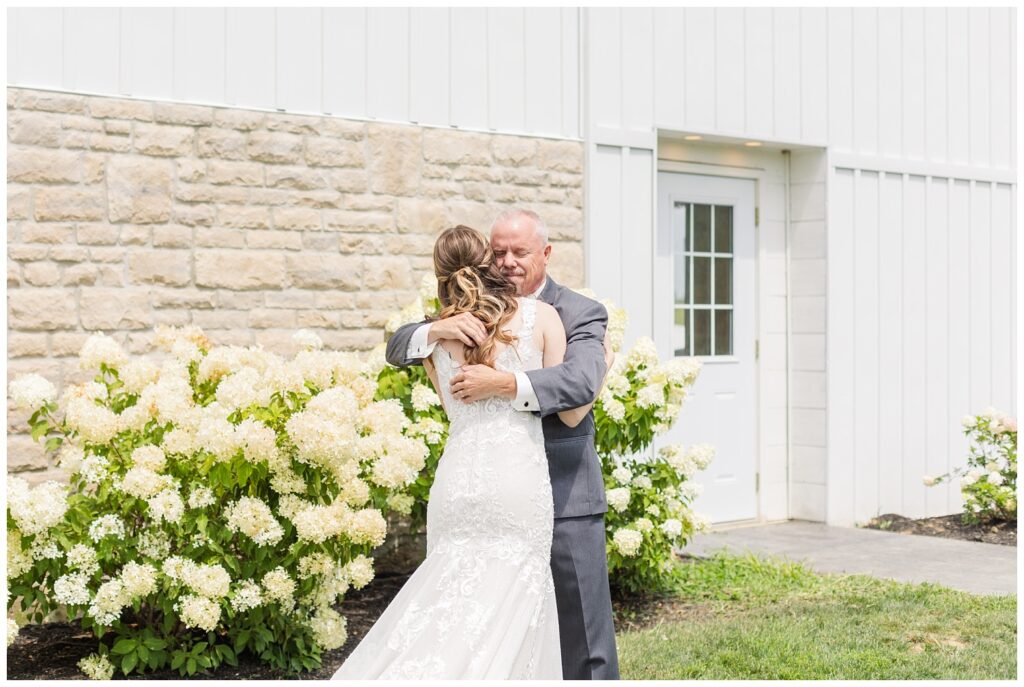 bride hugging dad during first look outside at Arlington Acres