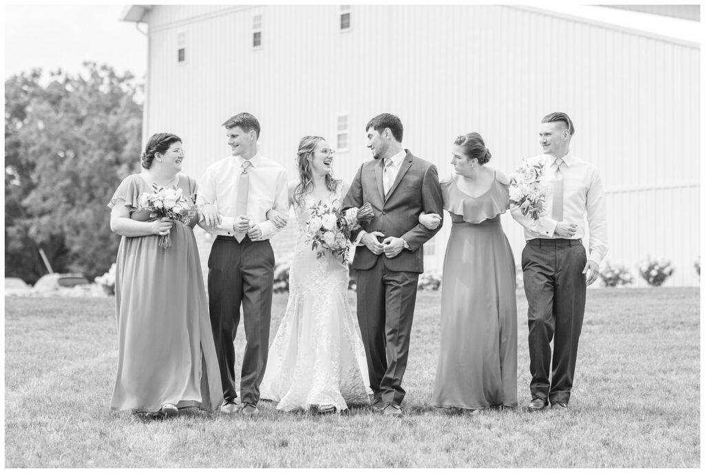 full bridal party walking on the grounds at Arlington Acres in Tiffin, Ohio