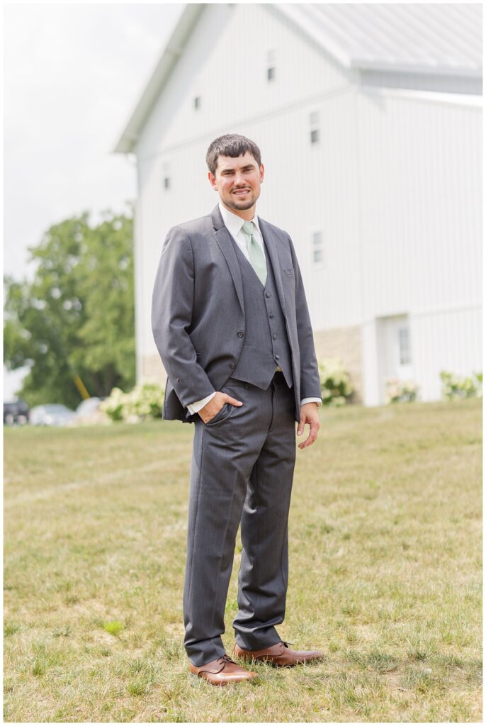 groom wearing a gray suit at Arlington Acres venue in Tiffin, Ohio