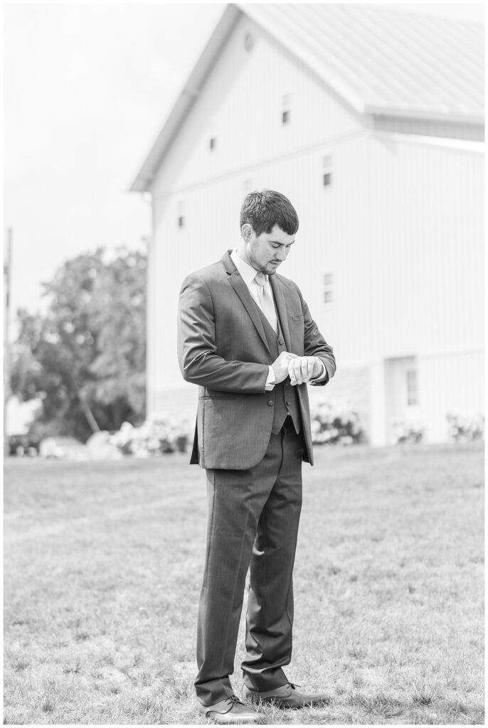 groom wearing a gray suit at Arlington Acres venue in Tiffin, Ohio