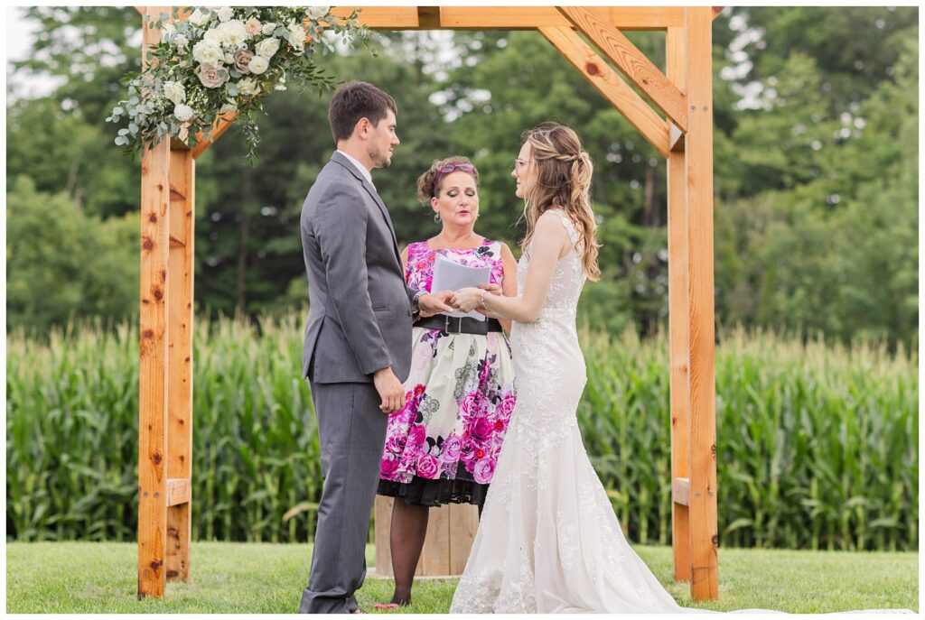wedding couple exchanging rings during ceremony in northwest Ohio