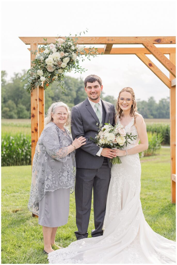 bride and groom posing with family in northwest Ohio