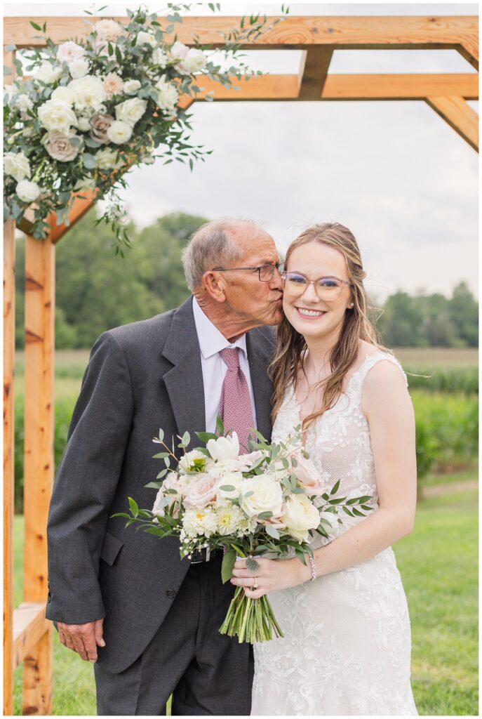bride posing with granddad at summer wedding in Tiffin, Ohio