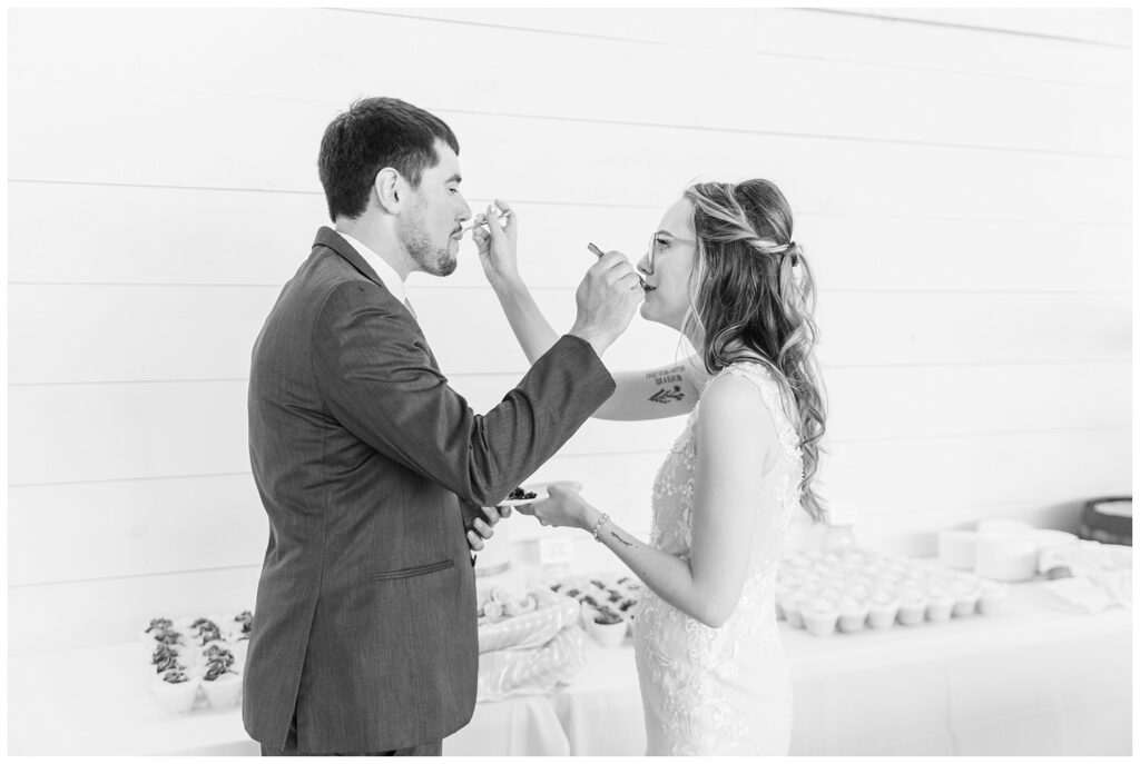 groom and bride cutting cake at Arlington Acres venue reception