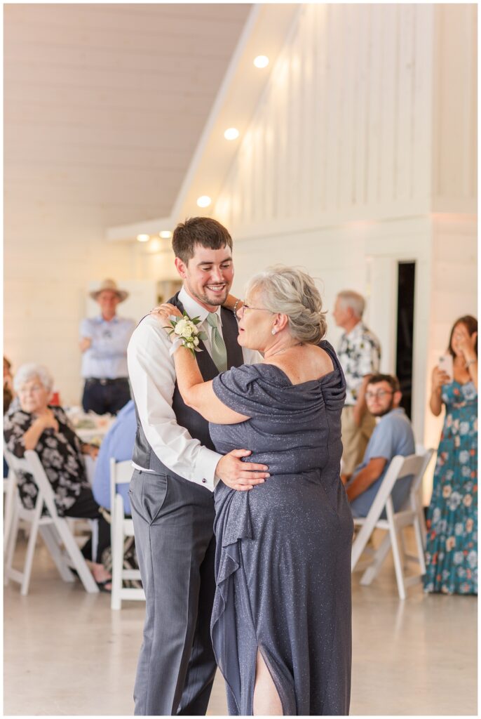 groom and his mom sharing a dance at summer wedding reception in Ohio
