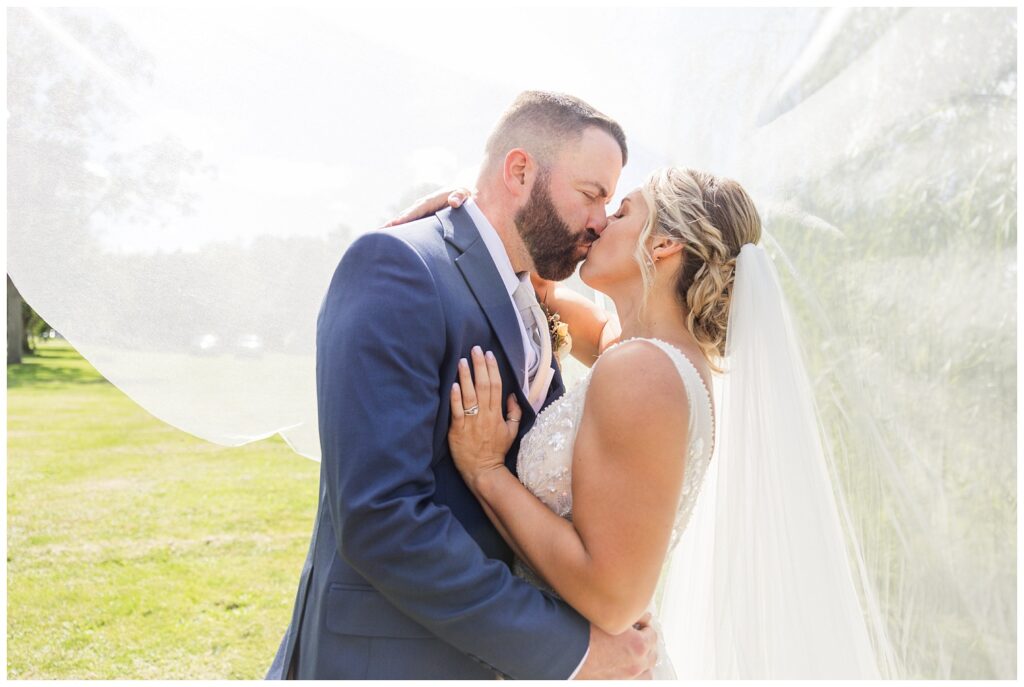 wedding couple kissing under the bride's veil in northwest Ohio