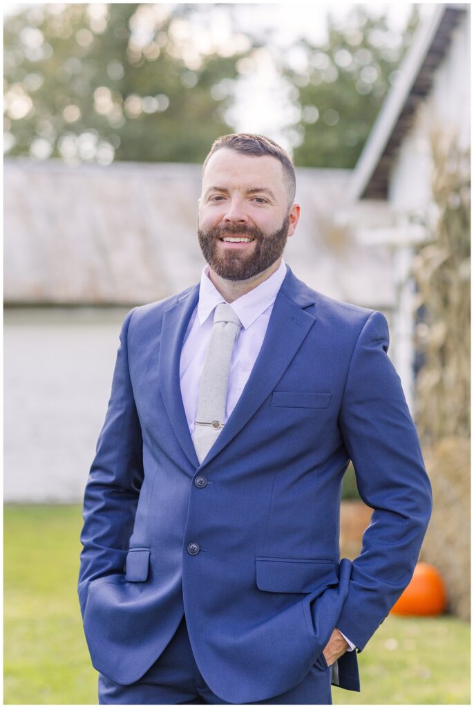 groom wearing a blue suit and ivory tie at fall wedding in northwest Ohio