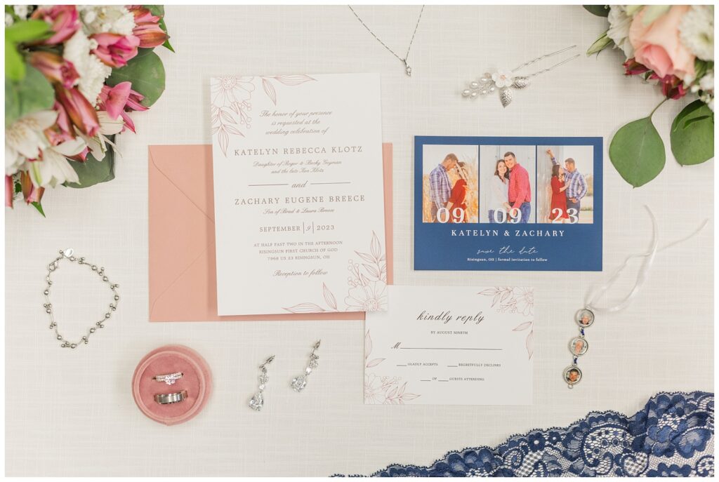wedding flat lay with jewelry, invitation and flowers in northwest Ohio