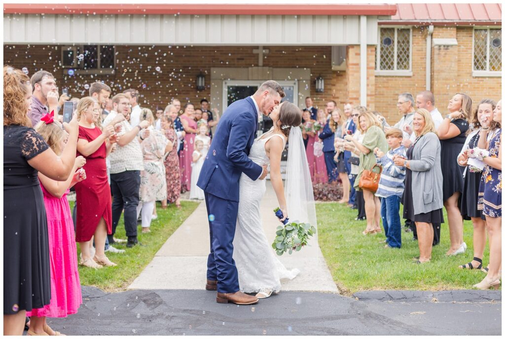 bride and groom kissing outside during planned bubble exit at northwest Ohio