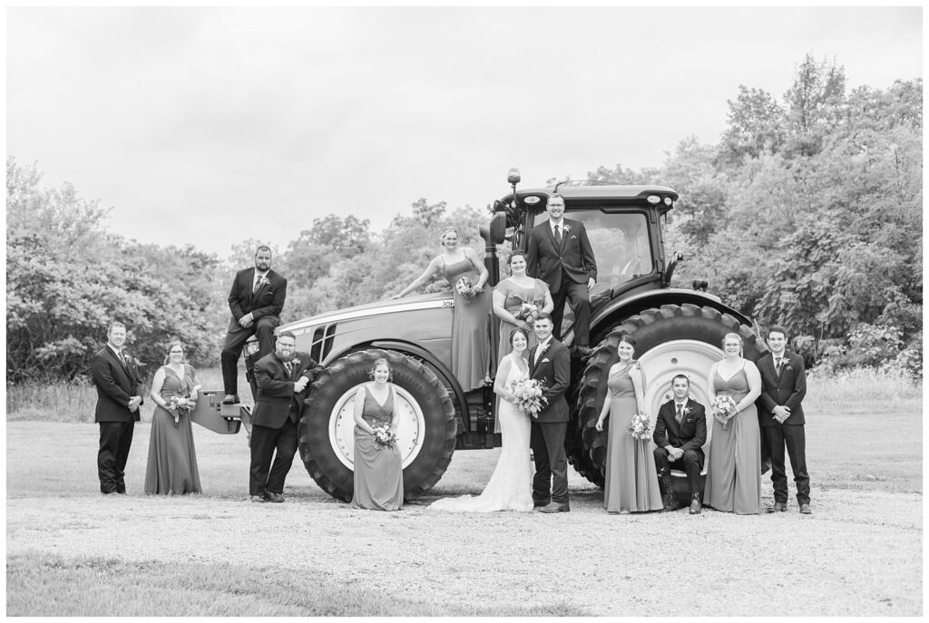 full wedding party posing with bride and groom's tractor in Bowling Green, Ohio