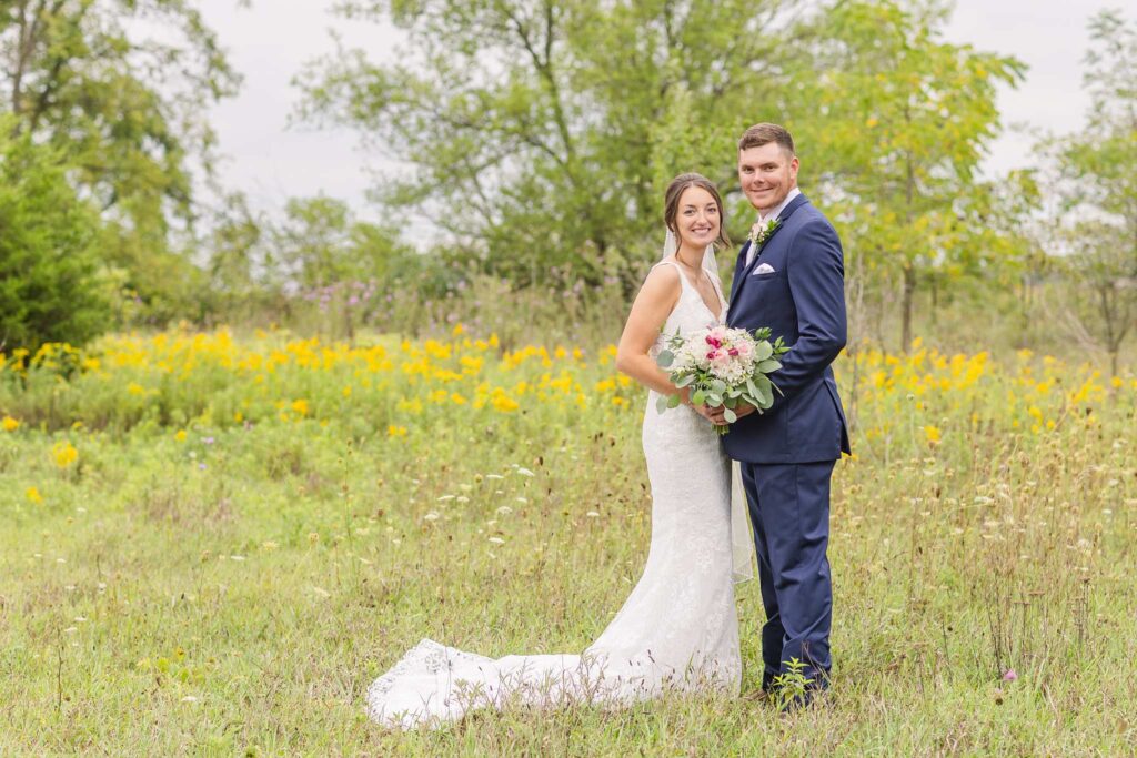 bride and groom posing on their farm in Bowling Green, Ohio