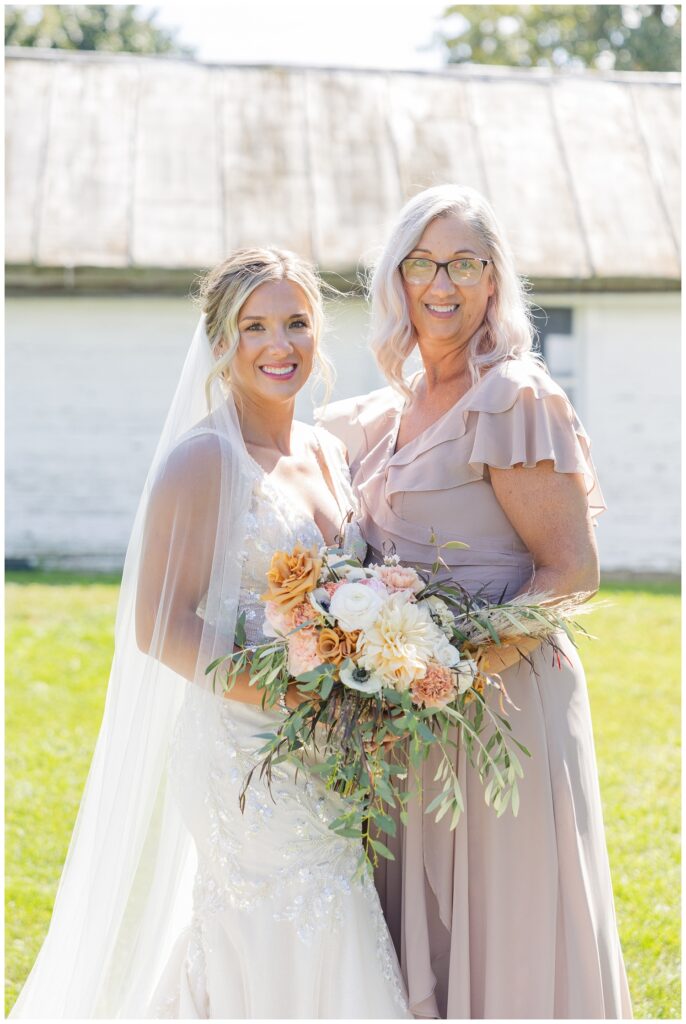 bride posing with her mom at fall wedding in northwest Ohio