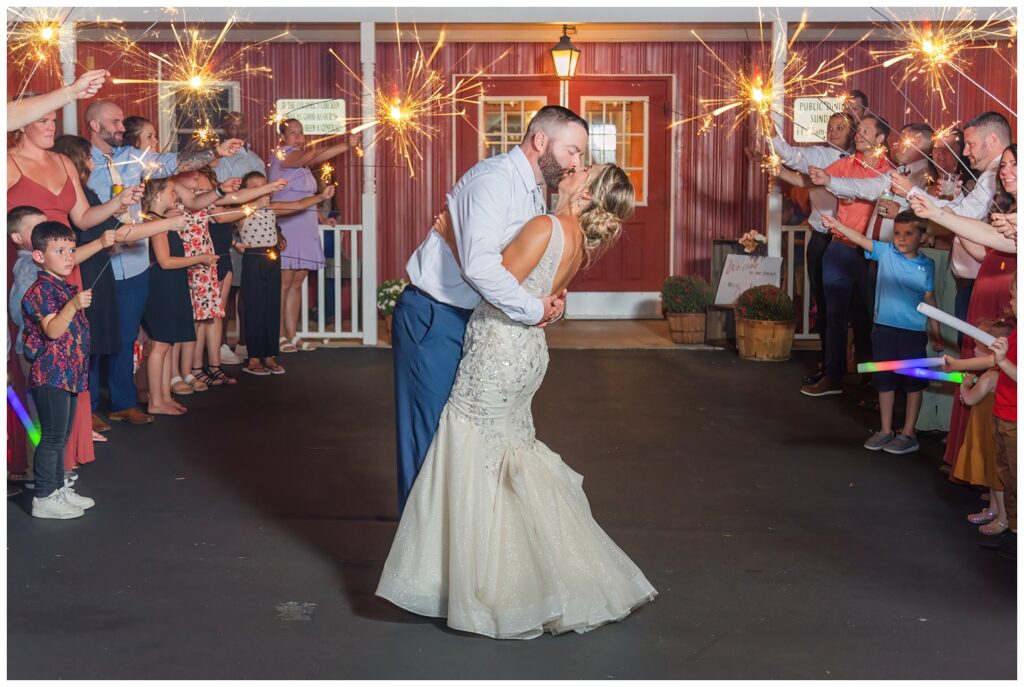 bride and groom kiss at sparkler exit at Ole Zim’s Wagon Shed wedding venue