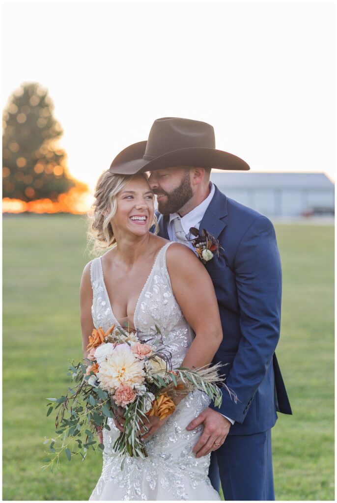 wedding couple pose for golden hour portraits at Ole Zim’s Wagon Shed venue
