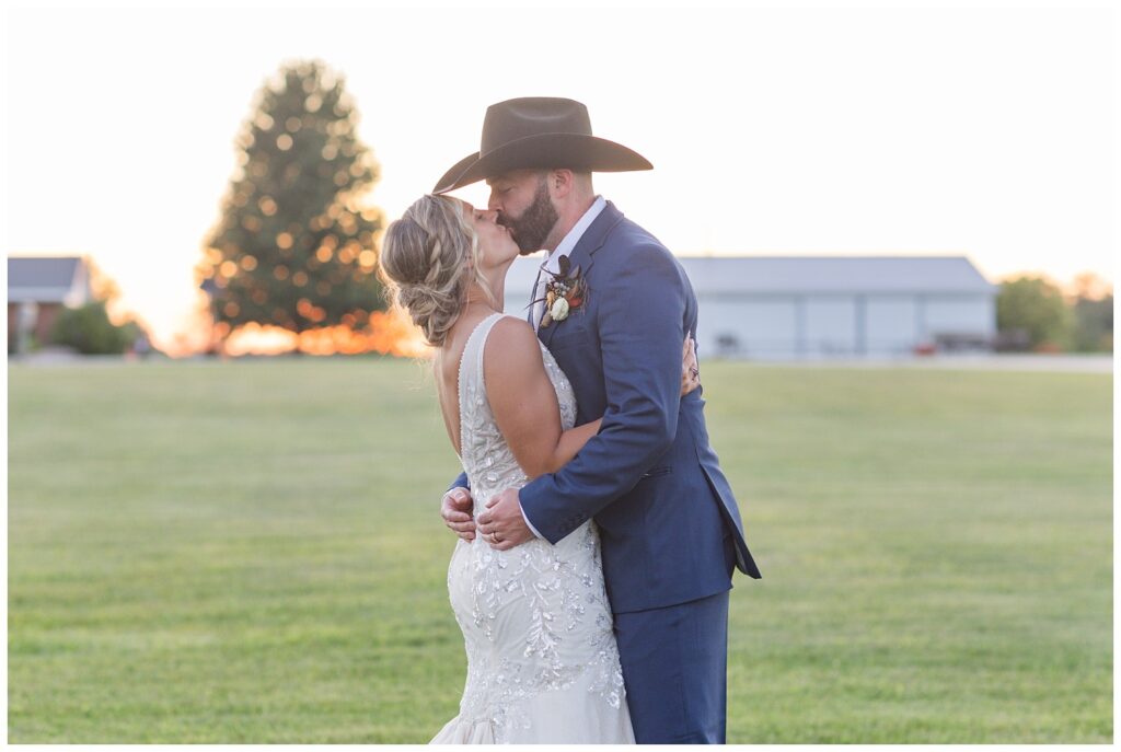 wedding couple pose for golden hour portraits at Ole Zim’s Wagon Shed venue