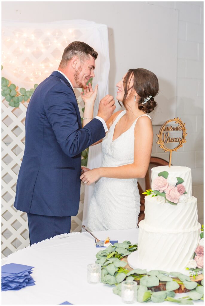 bride and groom cutting their cake at Woods County Fairgrounds reception