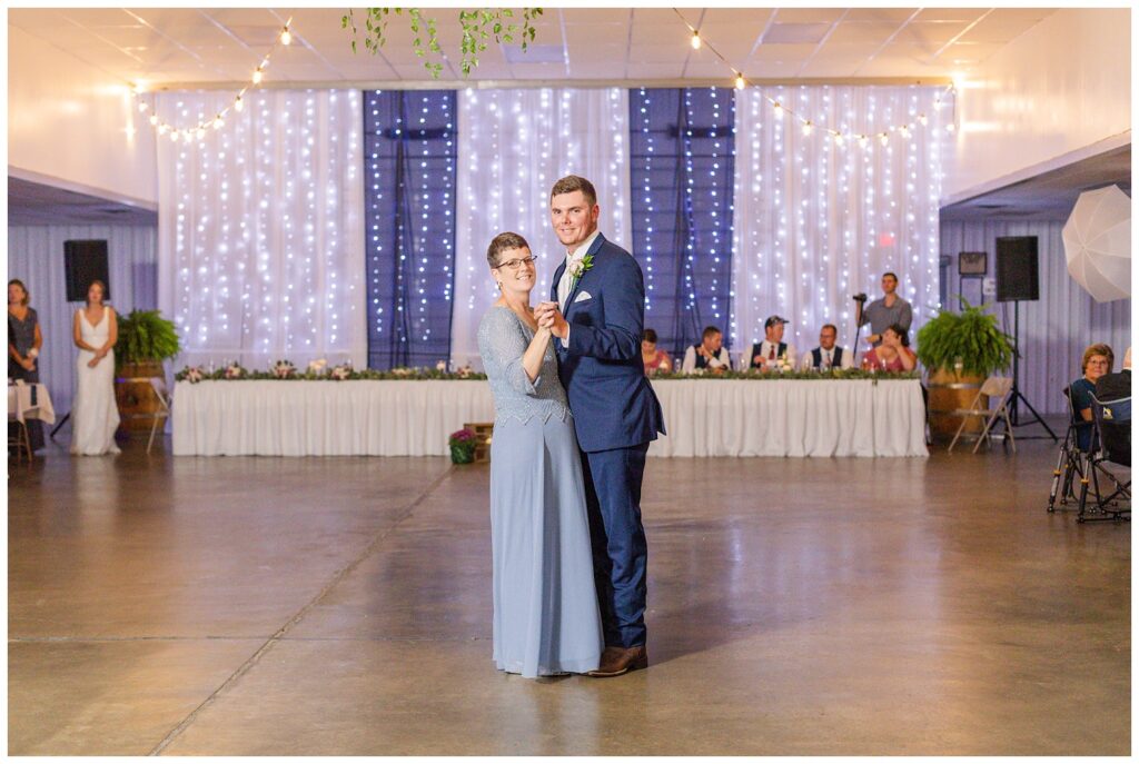 groom dancing with his mom at Wood Country Fairgrounds reception