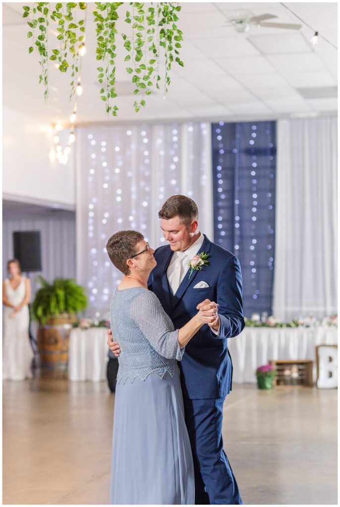 groom dancing with his mom at Wood Country Fairgrounds reception