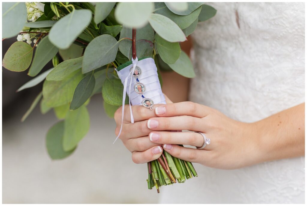 bride showing her bouquet charm of pictures with her grandparents and dad