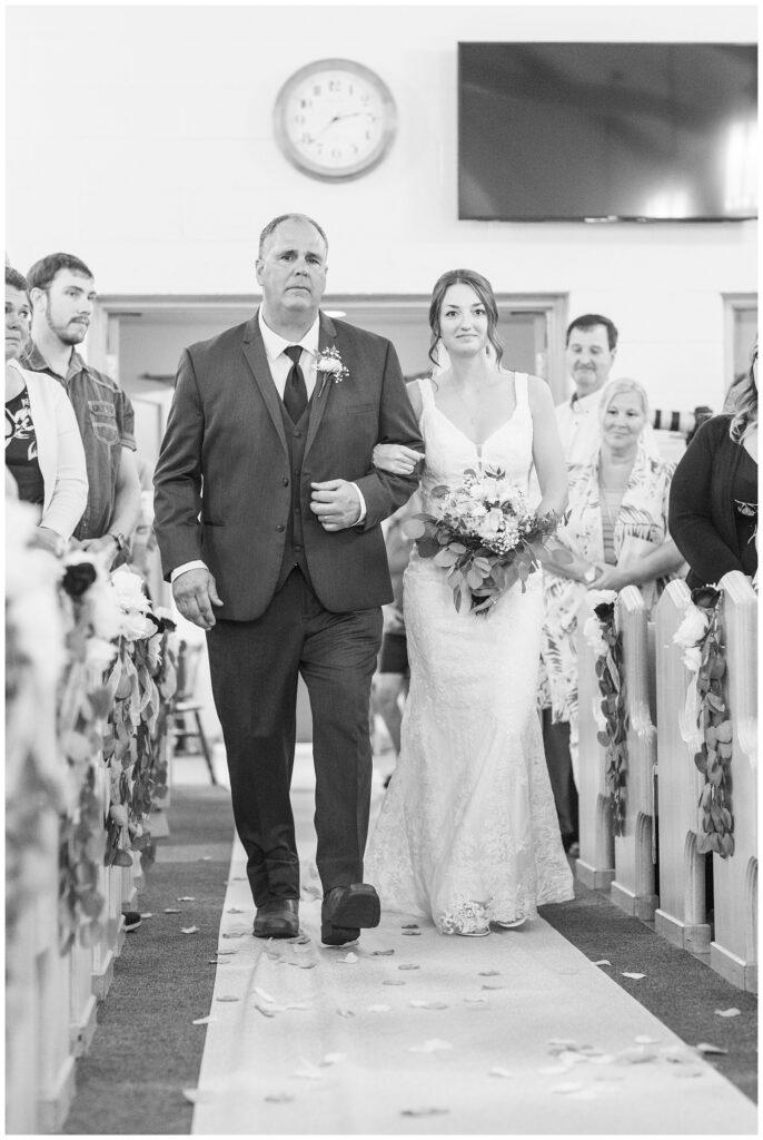 bride walking down the aisle with stepdad at Risingsun First Church of God