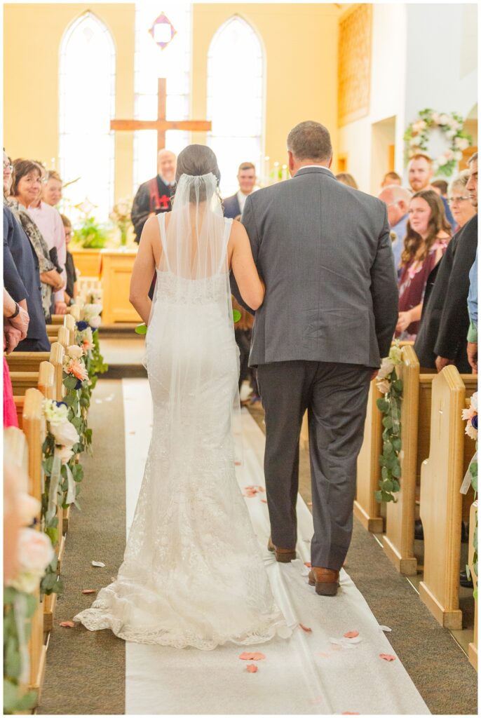 bride walking down the aisle with stepdad at Risingsun First Church of God