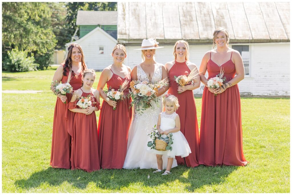 bridal party posing in front of a white barn in Gibsonburg, Ohio
