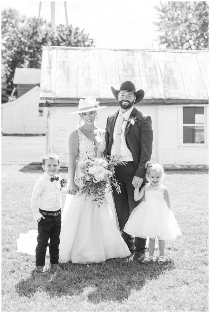 wedding couple posing with flower girl and ring bearer at fall ceremony 
