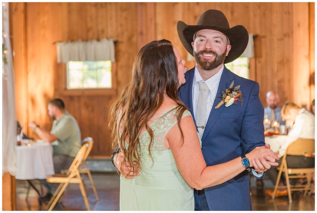 groom and mom share dance at wedding reception at Ole Zim’s Wagon Shed wedding venue 
