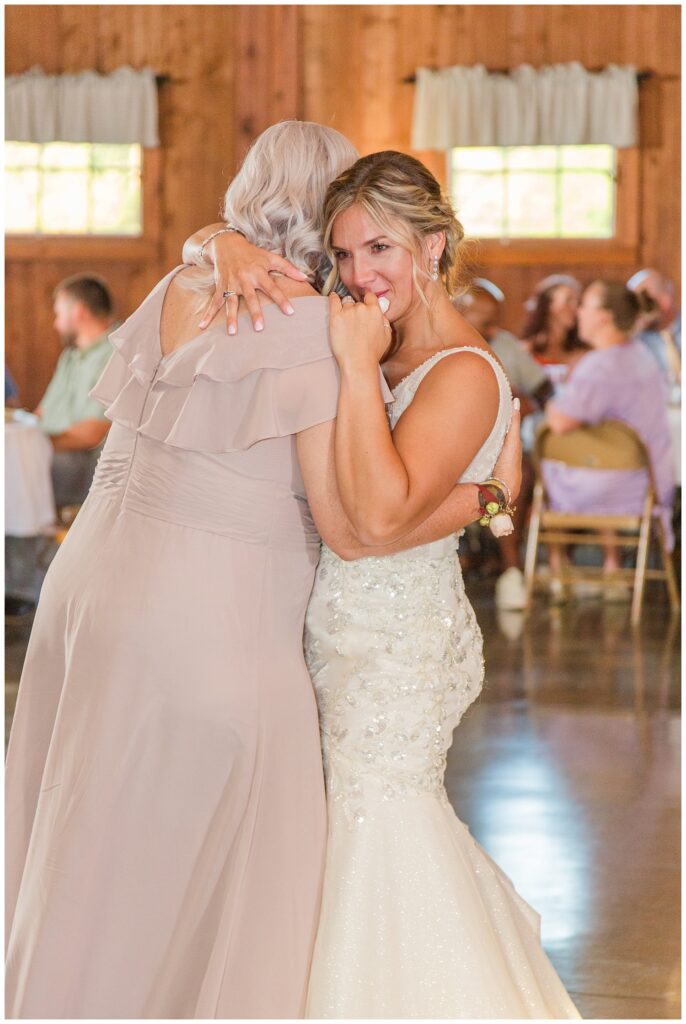 bride and her mom share dance at wedding reception at Ole Zim’s Wagon Shed wedding venue 