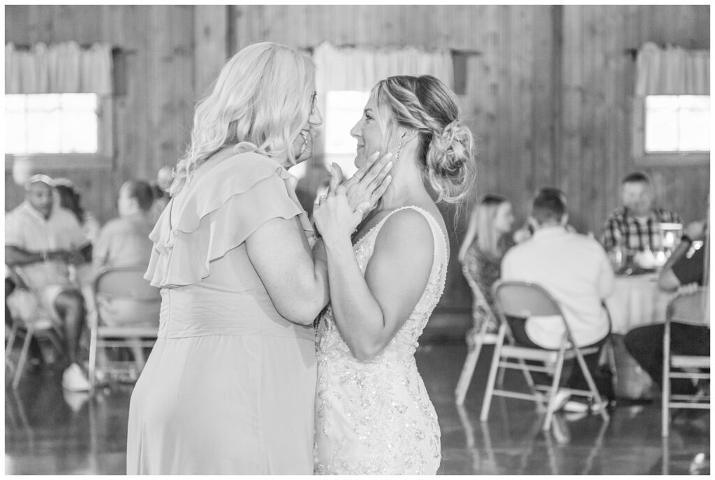 bride and her mom share dance at wedding reception at Ole Zim’s Wagon Shed wedding venue 