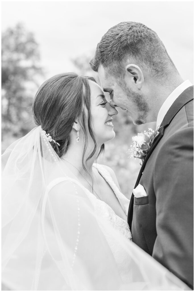 bride and groom touching noses for wedding portraits in northwest Ohio