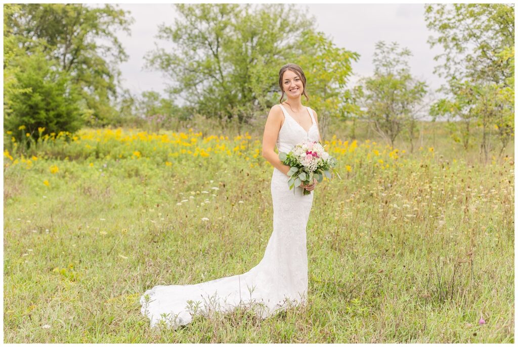 bride posing with her bouquet in her field on her farm in Bowling Green, Ohio