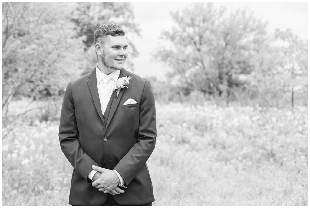 groom looks over at the bride on their farm in Bowling Green, Ohio